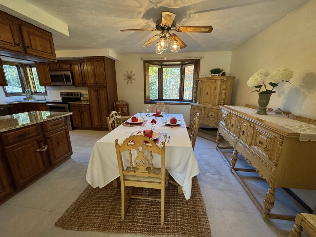 Cozy dining area with rustic wooden furniture and a ceiling fan.